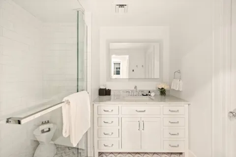 a bathroom with a sink vanity and mirror