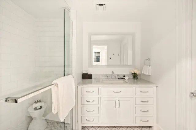 a bathroom with a sink vanity and mirror