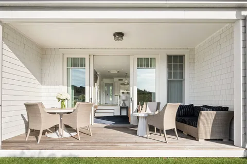 a dining room with furniture and wooden floor