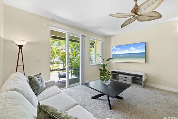 a living room with furniture a window and a flat screen tv