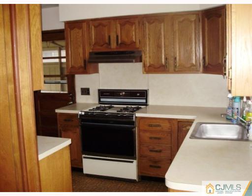 77 Princeton Road Old Bridge, NJ 08859 - Photo 2 of 8 a kitchen with granite countertop a stove and a sink
