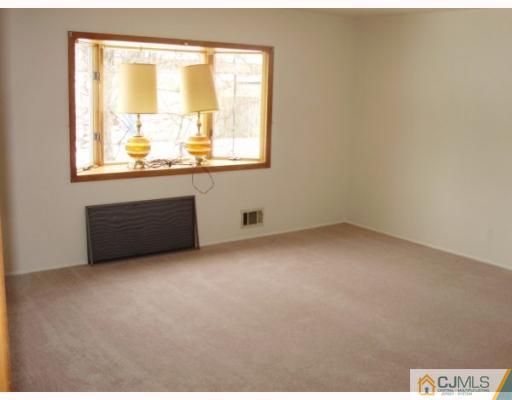77 Princeton Road Old Bridge, NJ 08859 - Photo 3 of 8 an empty room with a window