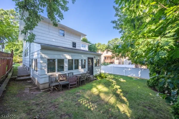 a view of a house with a yard porch and sitting area