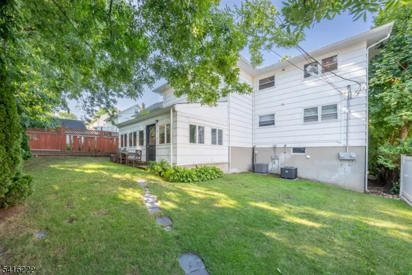 a view of a house with a backyard