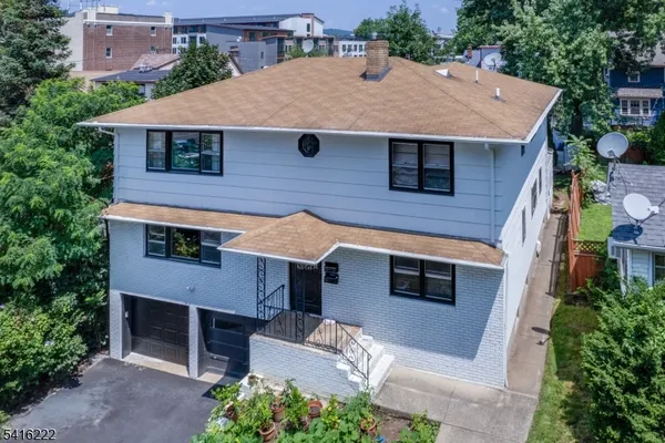 a aerial view of a house with a yard and garage