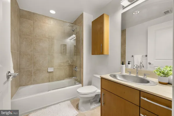 a bathroom with a sink a toilet and a bathtub