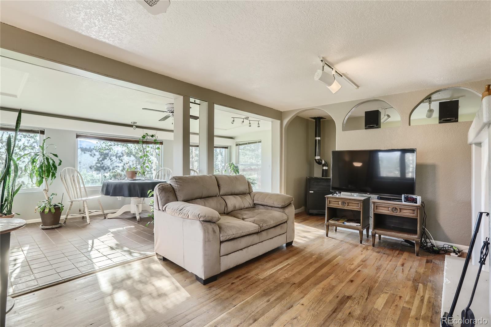 297 Neal Road Bailey, CO 80421 - Photo 2 of 17 a living room with furniture and a flat screen tv