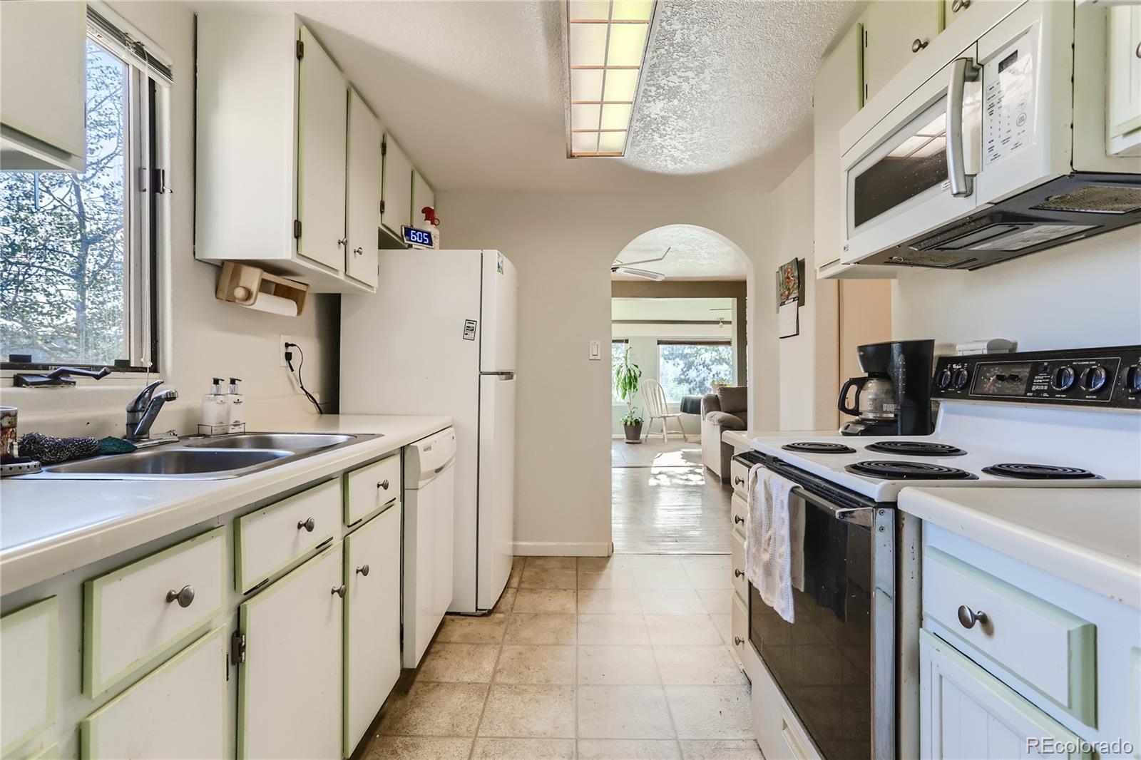 297 Neal Road Bailey, CO 80421 - Photo 5 of 17 a kitchen with stainless steel appliances granite countertop a stove and a sink