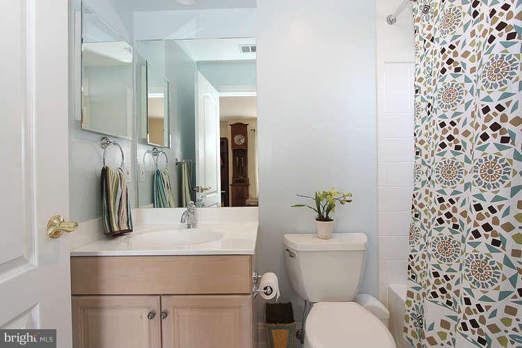 2038 Lord Fairfax Road Vienna, VA 22182 - Photo 15 of 24 a bathroom with a sink toilet and a mirror