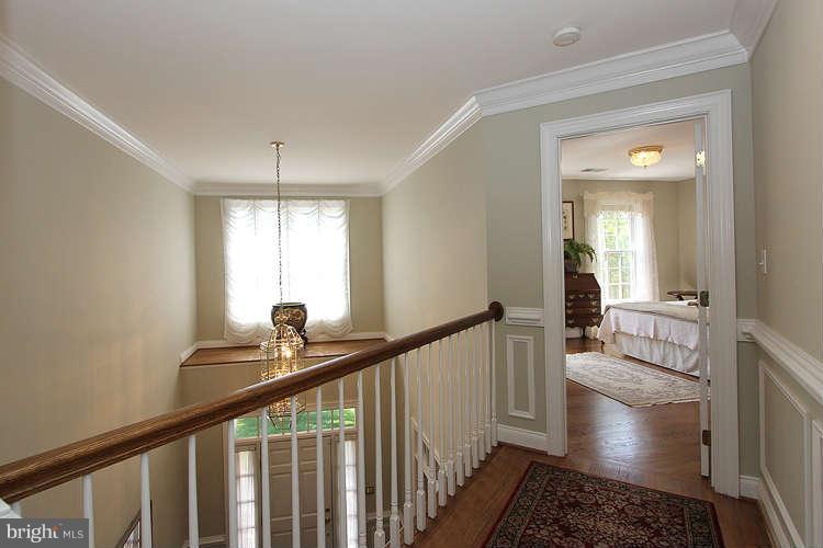 2038 Lord Fairfax Road Vienna, VA 22182 - Photo 16 of 24 a view of a hallway view with wooden floor and furniture
