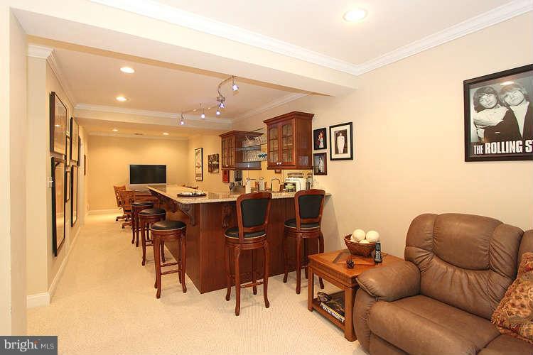 2038 Lord Fairfax Road Vienna, VA 22182 - Photo 18 of 24 a living room with lots of furniture and kitchen view