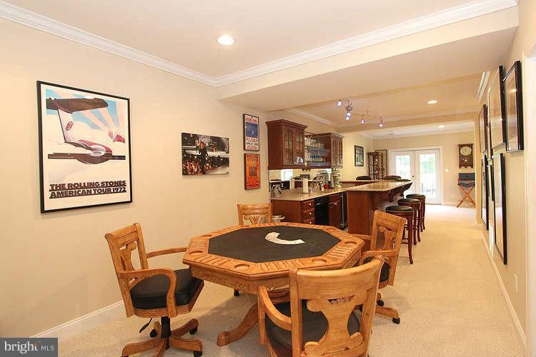 2038 Lord Fairfax Road Vienna, VA 22182 - Photo 19 of 24 a dining room with furniture and a kitchen view