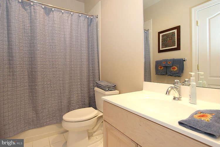 2038 Lord Fairfax Road Vienna, VA 22182 - Photo 20 of 24 a bathroom with a sink a toilet and a mirror