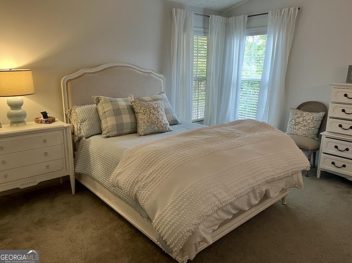 11 Winter Lane Newnan, GA 30265 - Photo 6 of 11 a large bed sitting in a bedroom next to a window