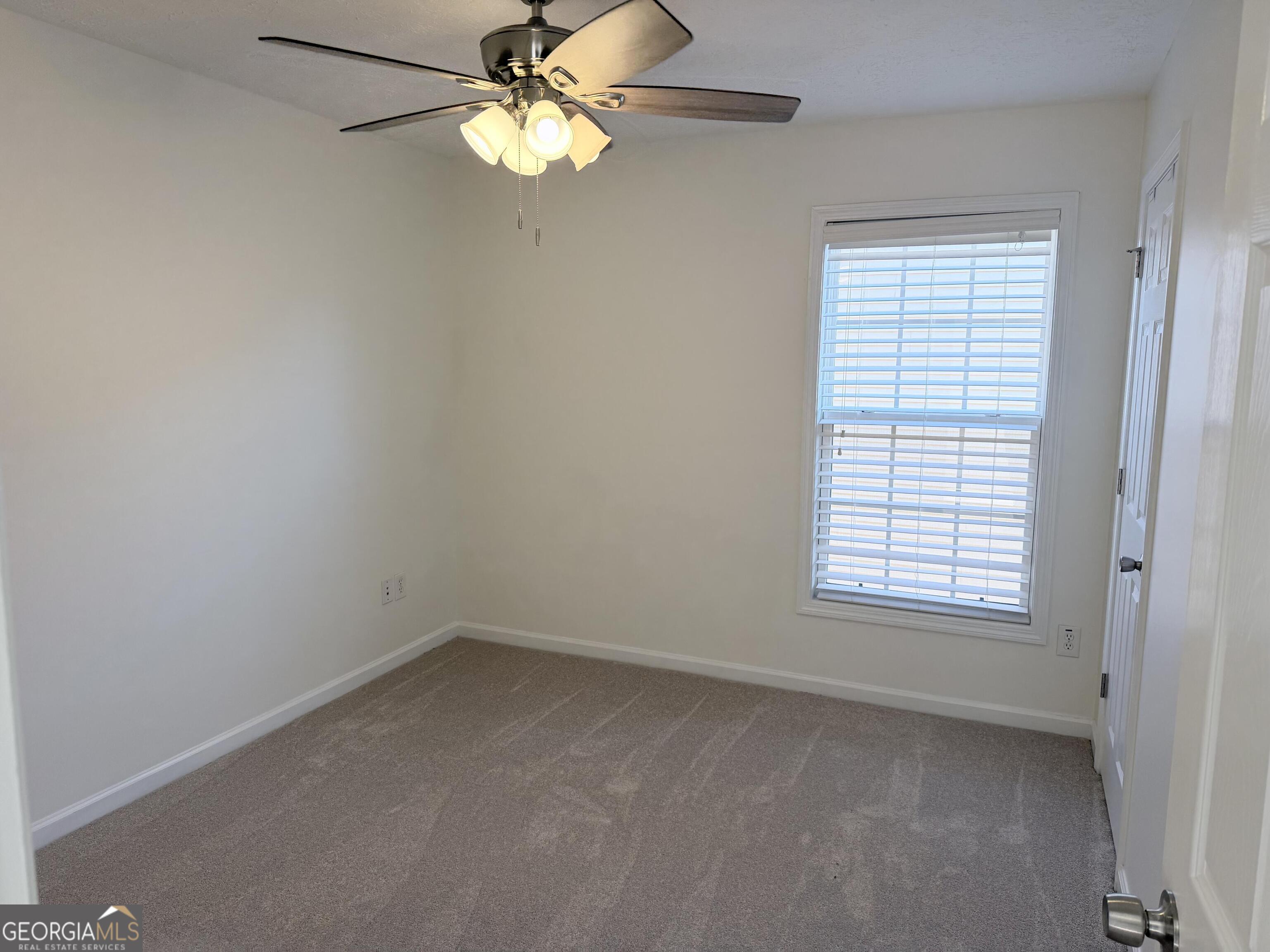 11 Winter Lane Newnan, GA 30265 - Photo 10 of 11 an empty room with a window and a fan