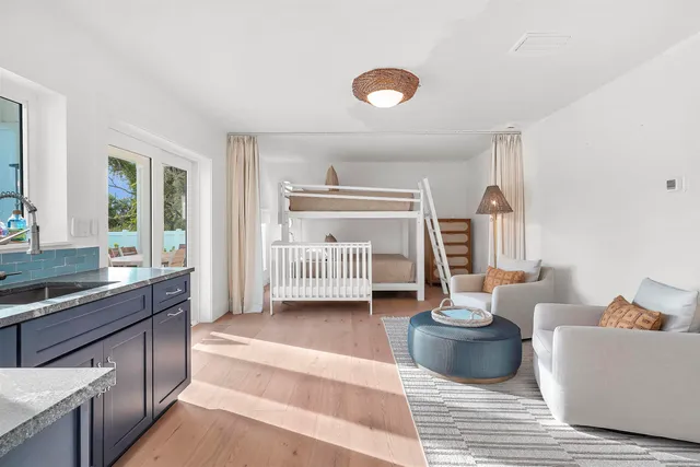 a living room with furniture a rug and white walls