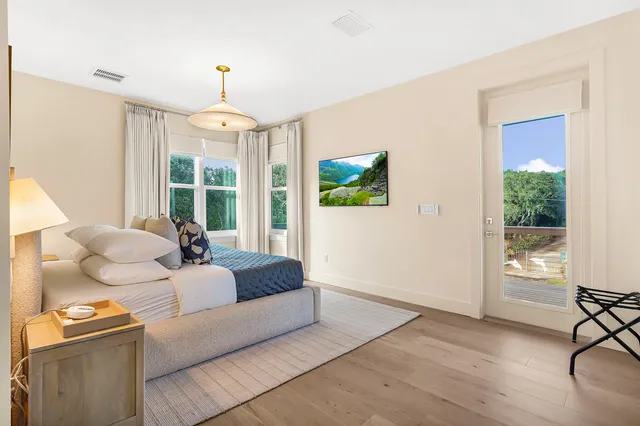 a bathroom with a granite countertop sink a toilet a mirror and shower