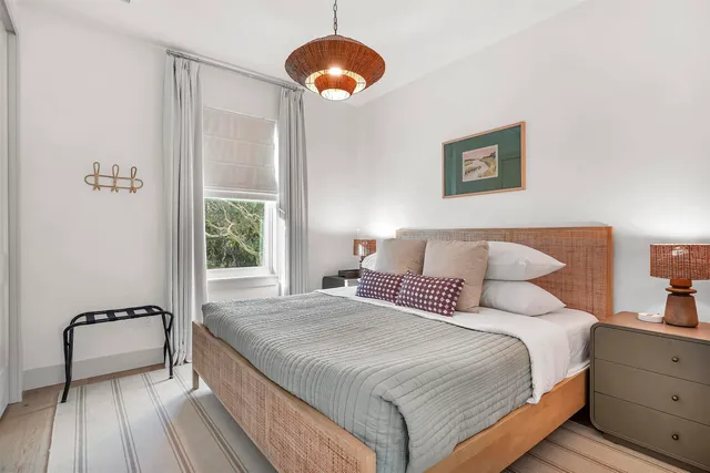 a bathroom with a granite countertop sink a toilet a and mirror