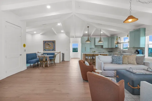 a large kitchen with stainless steel appliances granite countertop a sink a stove and a wooden floors