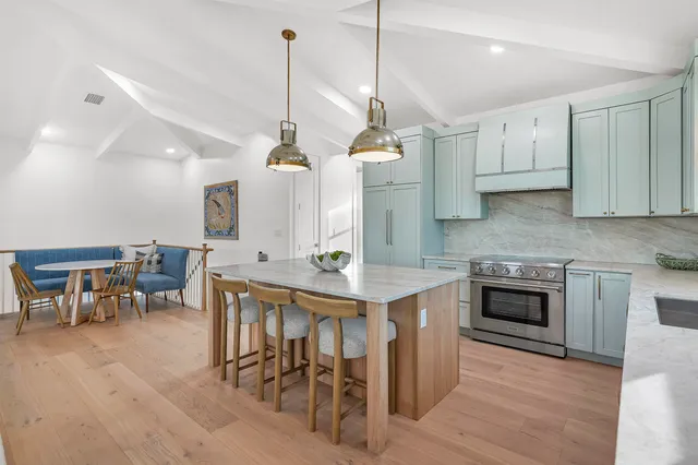 a living room with furniture a window and a dining table