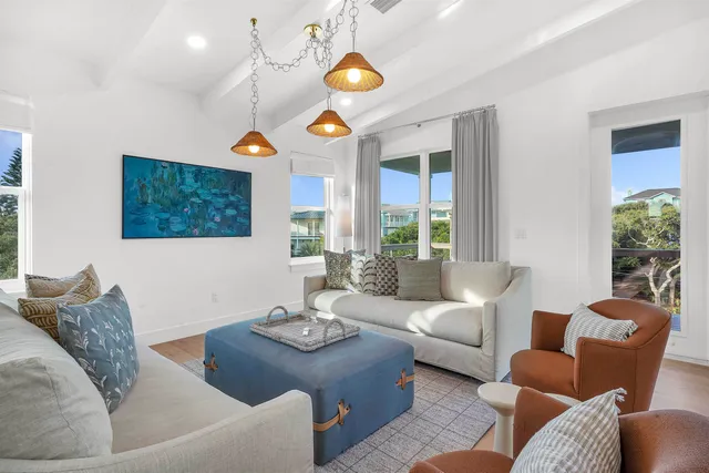 a balcony with wooden floor table and chairs