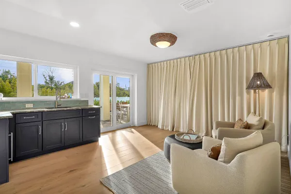 a living room with hard wood flooring and furniture