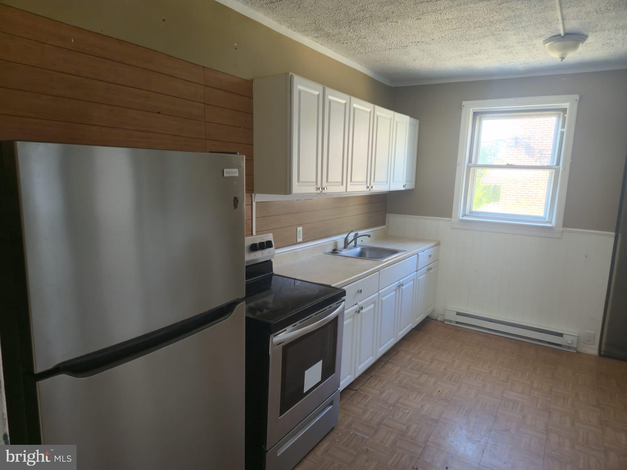 a utility room with faucet washer and dryer