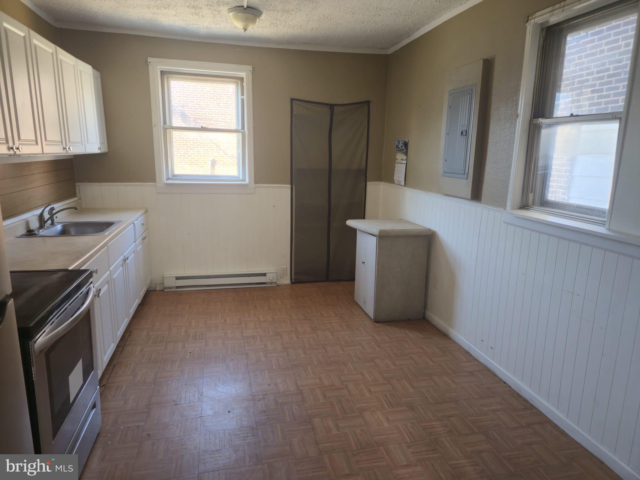4584 G Street Philadelphia, PA 19120 - Photo 2 of 10 a view of a kitchen with a sink dishwasher and a fireplace