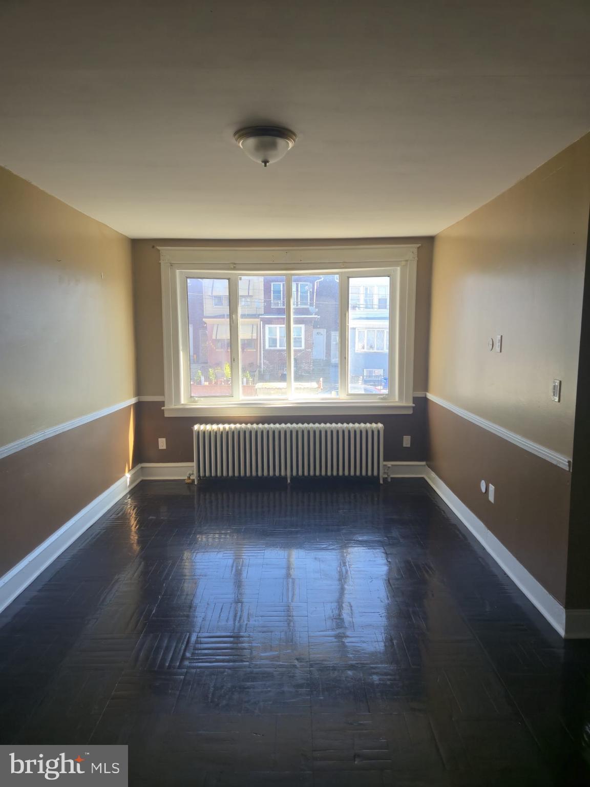 4584 G Street Philadelphia, PA 19120 - Photo 5 of 10 a view of an empty room with wooden floor and a window