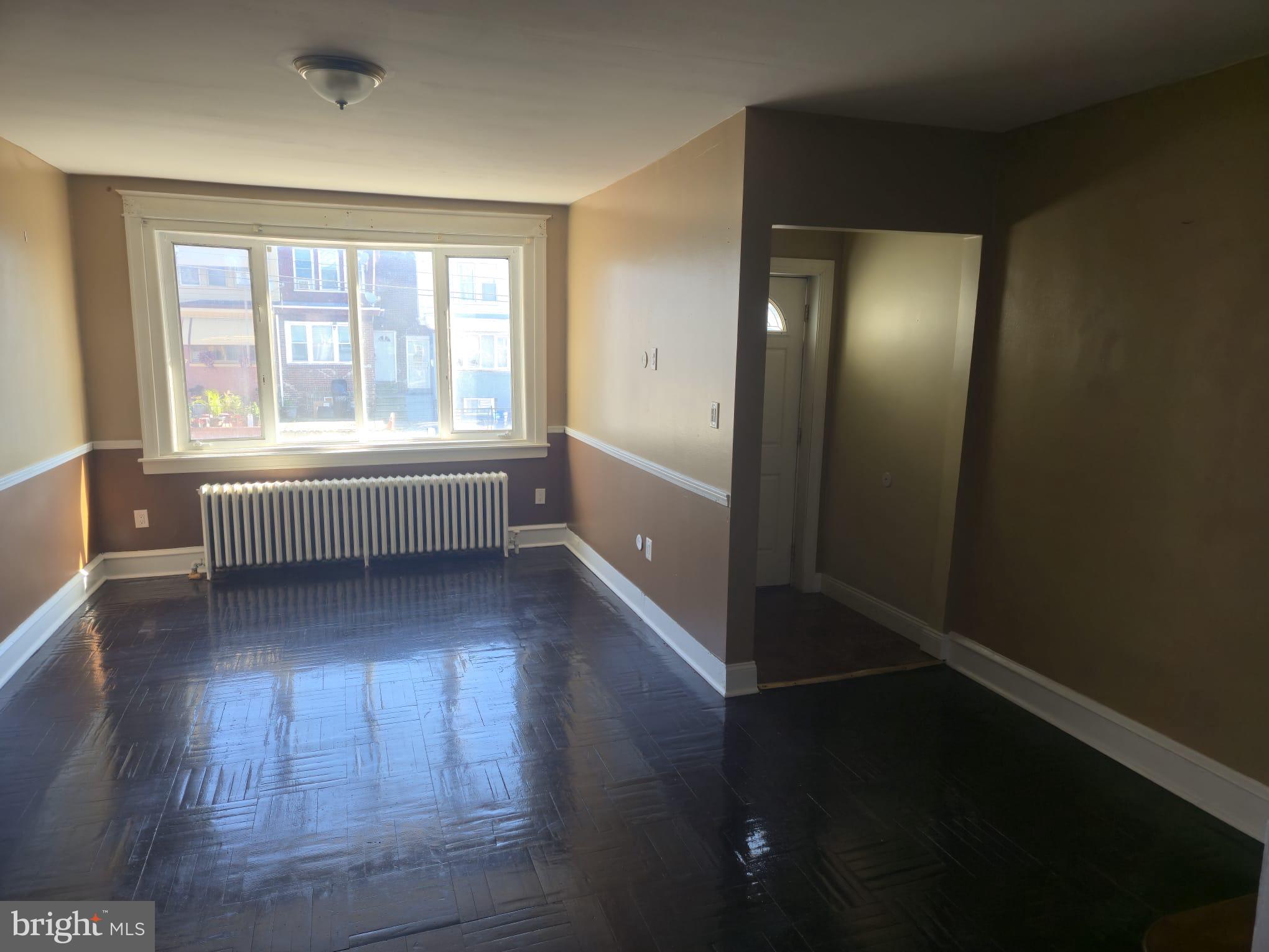 4584 G Street Philadelphia, PA 19120 - Photo 6 of 10 wooden floor in an empty room with a window