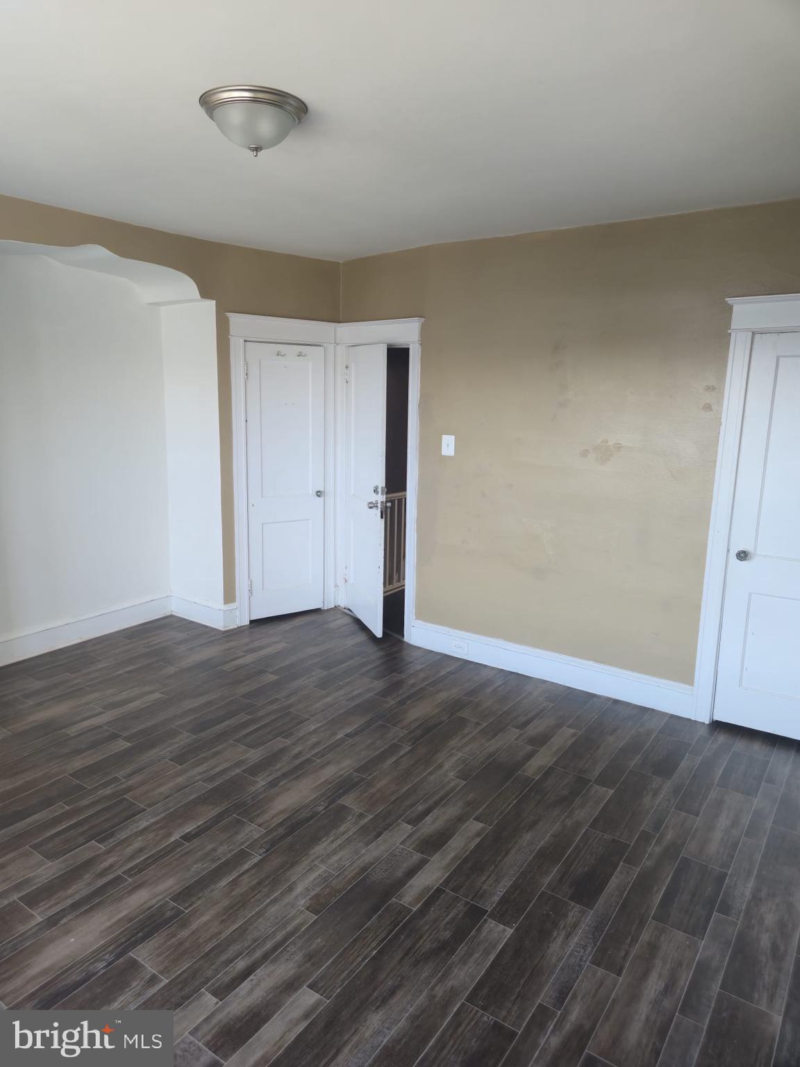 4584 G Street Philadelphia, PA 19120 - Photo 7 of 10 a view of an empty room with wooden floor and closet