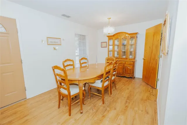 a dining room with furniture and wooden floor