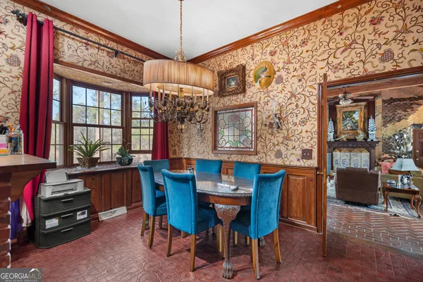 a view of a dining room with furniture and chandelier