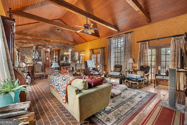 a living room with fireplace furniture and a large window