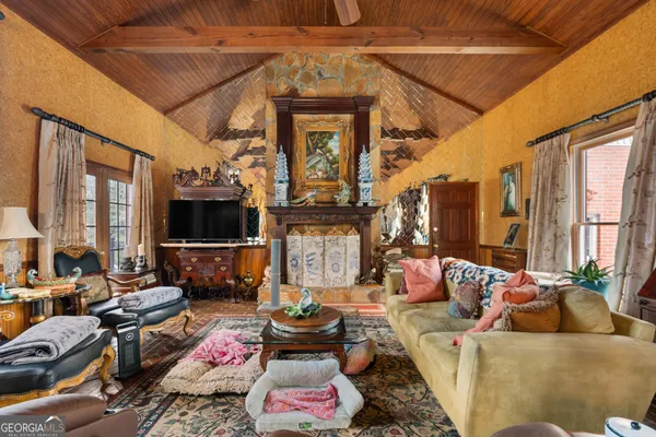 a living room with furniture and a chandelier