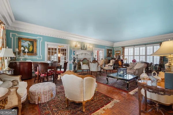 a living room with fireplace furniture and a large window