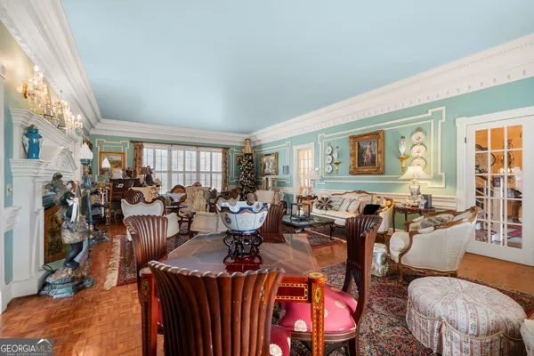 a living room with couch a table and a chandelier