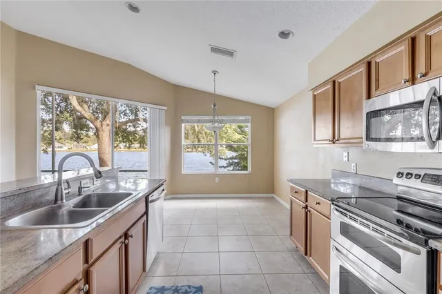 a kitchen with a sink stove top oven and cabinets