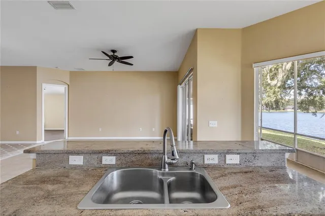 a kitchen with a sink and a large window