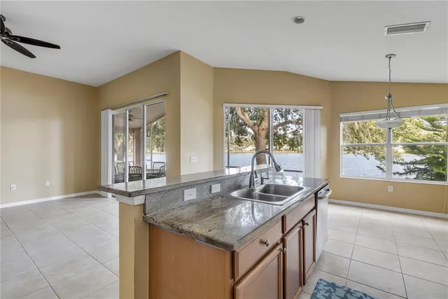 a kitchen with granite countertop a sink and a window