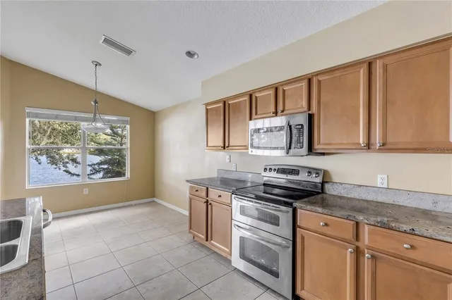 a kitchen with stainless steel appliances a stove sink and cabinets