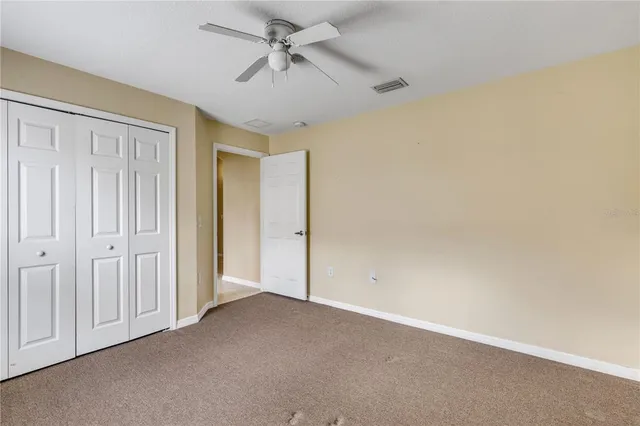 a view of empty room with a fan