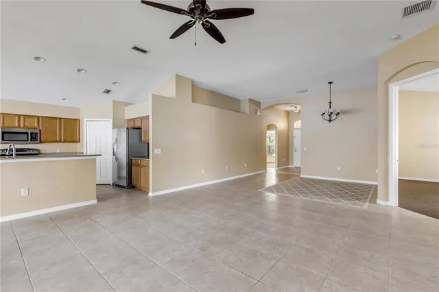 a view of a kitchen with a sink and stainless steel appliances