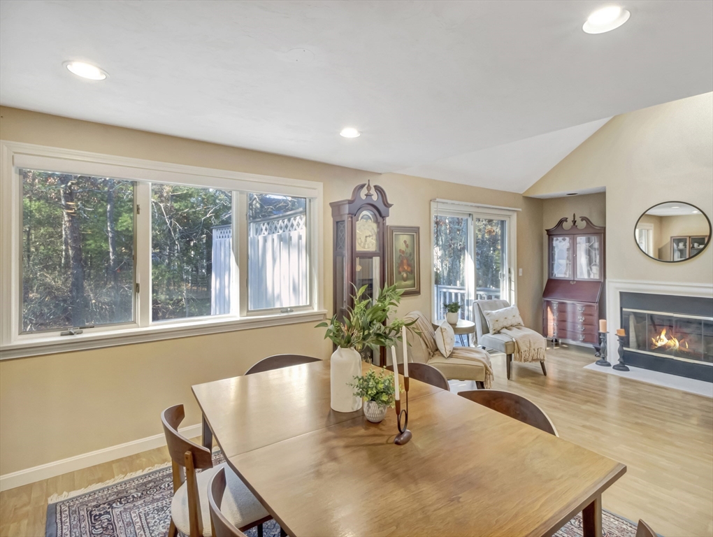 10 Kettle Lane, Unit 10 Mashpee, MA 02649 - Photo 12 of 25 a living room with fireplace furniture and a large window