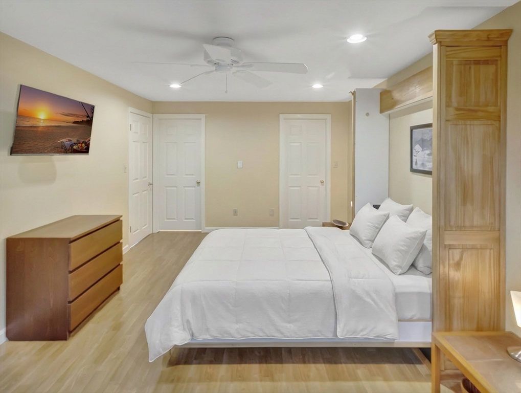 10 Kettle Lane, Unit 10 Mashpee, MA 02649 - Photo 22 of 25 a bedroom with a bed and a flat screen tv