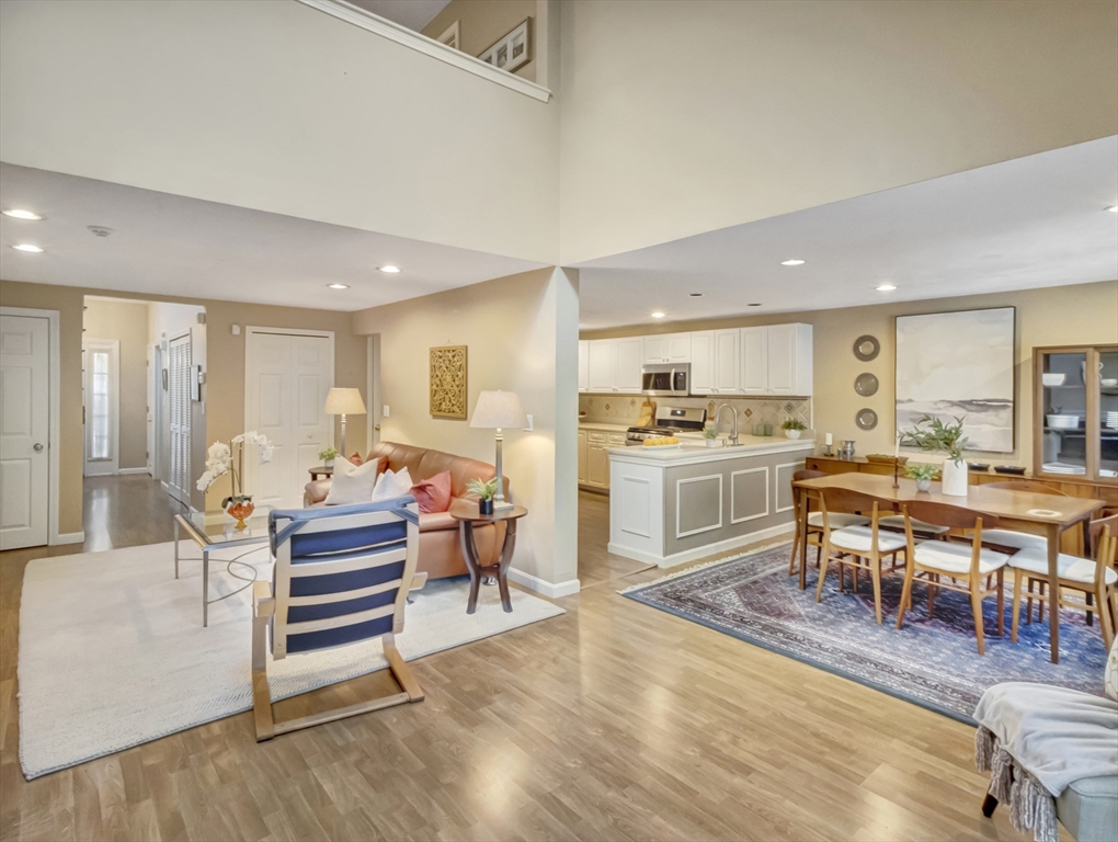 10 Kettle Lane, Unit 10 Mashpee, MA 02649 - Photo 4 of 25 a living room with lots of furniture and kitchen view