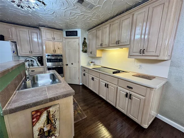 a kitchen with stainless steel appliances granite countertop a stove a sink dishwasher and a refrigerator