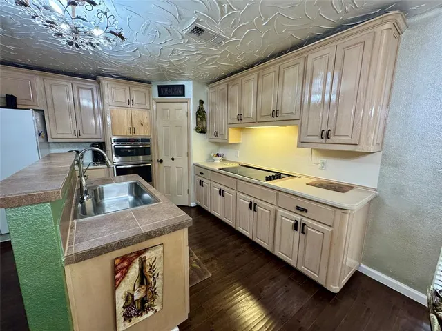 a kitchen with stainless steel appliances granite countertop a stove a sink dishwasher and a refrigerator