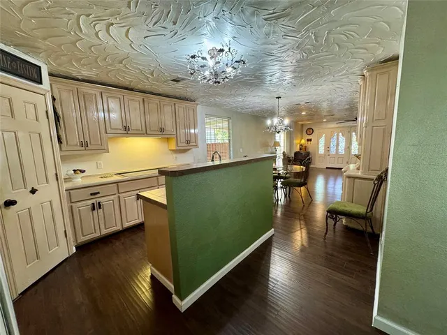 a kitchen with granite countertop a stove a sink and a refrigerator