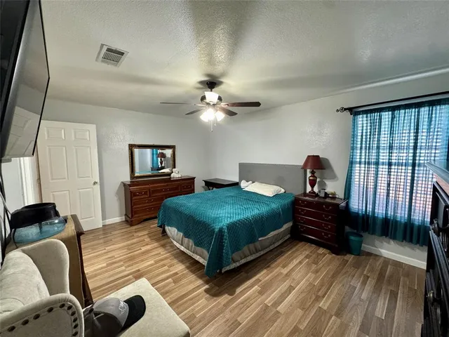 a bedroom with furniture and a large window